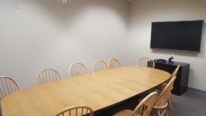 SUB 1113 videoconference room - pictures shows camera, microphone, large TV monitor and 10-12 person table